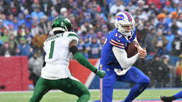 Buffalo Bills QB Josh Allen runs around New York Jets CB Sauce Gardner